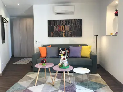 a living room with a couch and a table at Coccinelle in Nice