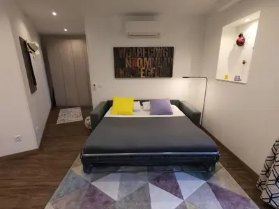 a bedroom with a bed with three pillows on it at Coccinelle in Nice