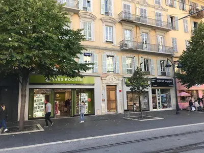 a group of shops in front of a building at Chouette Massena in Nice