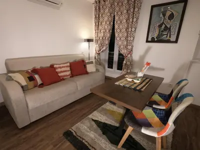 a living room with a couch and a table at Chouette Massena in Nice