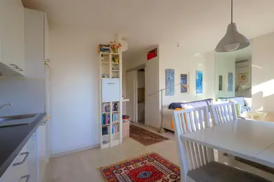a kitchen and dining room with a table and chairs at Le lutin in Saint-Laurent-du-Var