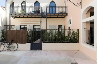 a bike parked next to a building with balconies at Patio Wilson in Nice