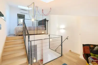 a staircase in a living room with a glass wall at Patio Wilson in Nice