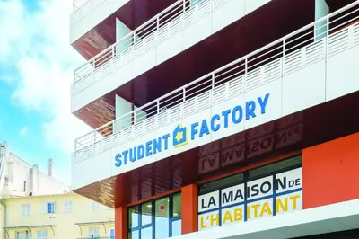 a building with a sign on the side of it at Student Factory Nice in Nice