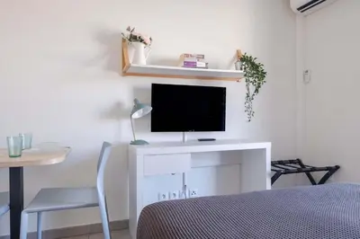 a room with a white desk with a television on it at Student Factory Nice in Nice