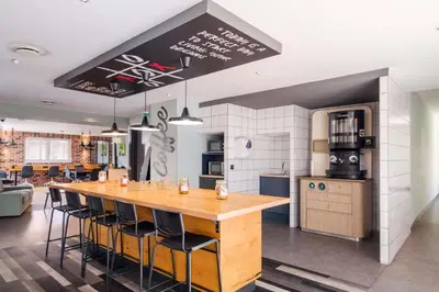 a kitchen with a large wooden table and chairs at Student Factory Nice in Nice