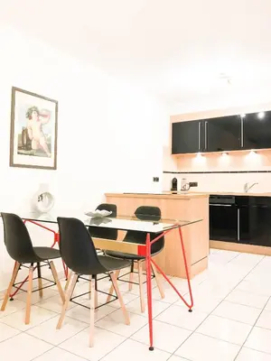 a kitchen with a table and chairs in a room at Portobello residence in Nice