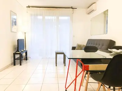 a living room with a table and a couch at Portobello residence in Nice