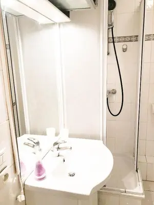 a white bathroom with a sink and a shower at Portobello residence in Nice