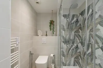 a bathroom with a toilet and a glass shower at Suite Relax Five Stars Holiday House in Nice