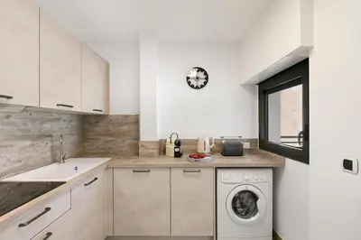 a kitchen with a washing machine and a sink at Suite Relax Five Stars Holiday House in Nice