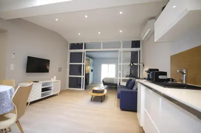 a kitchen and living room with a couch and a bed at WAVEBNB All Confort, central, parking in Nice