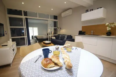 a white table with bread on it in a kitchen at WAVEBNB All Confort, central, parking in Nice