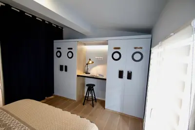a bedroom with a bed and a desk in a room at WAVEBNB All Confort, central, parking in Nice