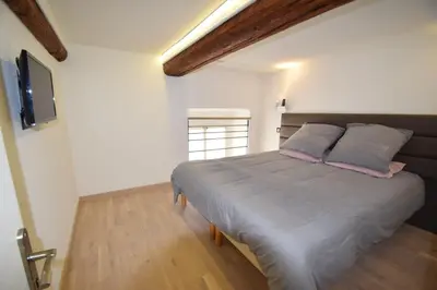 a bedroom with a bed and a tv on the wall at Jade Duplex - No Better Location In Nice in Nice