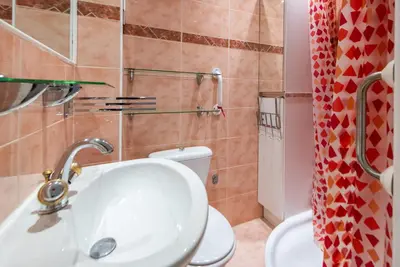 a bathroom with a sink and a toilet at The Queen in Nice