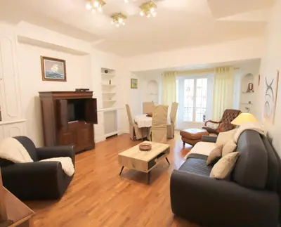 a living room with two couches and a table at The Queen in Nice