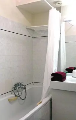a white bathroom with a tub and a sink at Cosy - Negresco - AC - 5 min walk to Beach in Nice