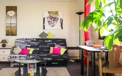 a living room with a couch and a table at Cosy - Negresco - AC - 5 min walk to Beach in Nice