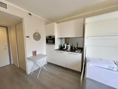 a small kitchen with a bed and a table in a room at ApartHotel Riviera Nice Côte d'Azur - Old Town - Studio AC - Sea View - 50m Promenade des Anglais- LA MAISON LINDA in Nice