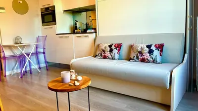 a living room with a couch and a table at ApartHotel Riviera Nice Côte d'Azur - Old Town - Studio AC - Sea View - 50m Promenade des Anglais- LA MAISON LINDA in Nice