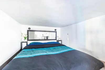 a bedroom with a large bed with a large mirror at JEAN MÉDECIN - Modern Flat - Heart of center in Nice