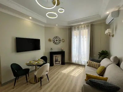 a living room with a couch and a table at Amour-35 in Nice