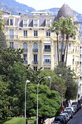 a large building with cars parked in front of it at Amour-35 in Nice