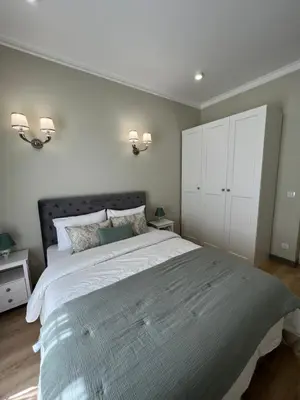 a bedroom with a large bed and white cabinets at Amour-35 in Nice