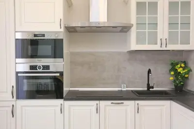 a kitchen with white cabinets and a sink and a stove at Le Charme-35 in Nice