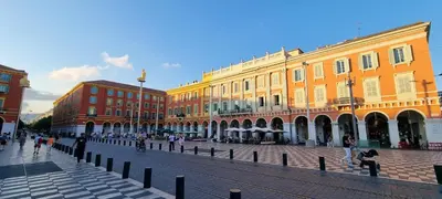 a city street with buildings and people walking around at Alery apartment Nice terrace AC wifi by Affitto-Nizza in Nice