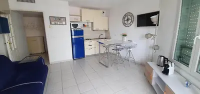 a kitchen with a blue refrigerator and a table at Alery apartment Nice terrace AC wifi by Affitto-Nizza in Nice
