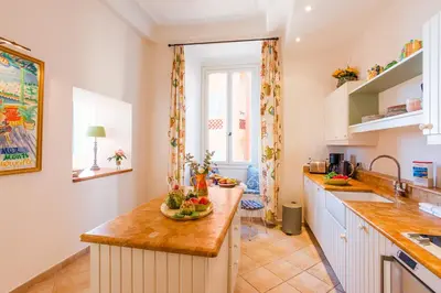 a kitchen with a counter with fruits and vegetables on it at ON VILLEFRANCHE BAY - AP3040 by Riviera Holiday Homes in Villefranche-sur-Mer