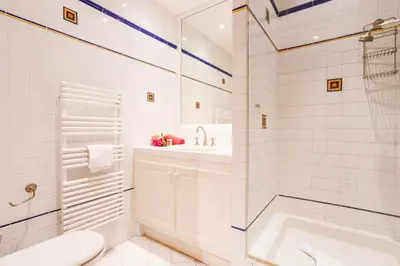 a bathroom with a tub and a sink and a toilet at ON VILLEFRANCHE BAY - AP3040 by Riviera Holiday Homes in Villefranche-sur-Mer