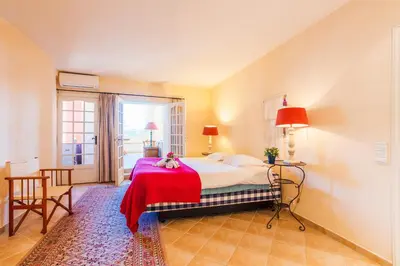 a bedroom with a bed with a red blanket at ON VILLEFRANCHE BAY - AP3040 by Riviera Holiday Homes in Villefranche-sur-Mer