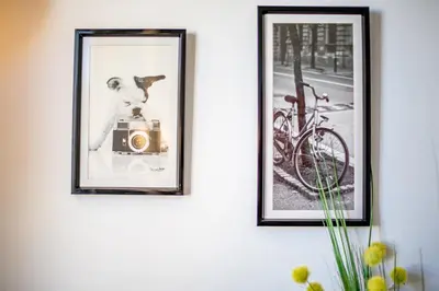 two pictures of a dog with a camera on a wall at Palais l'Escurial AP4069 by Riviera Holiday Homes in Nice