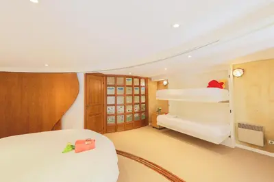 a bedroom with two bunk beds and a desk at Quai des Marinières AP2015 by Riviera Holiday Homes in Villefranche-sur-Mer