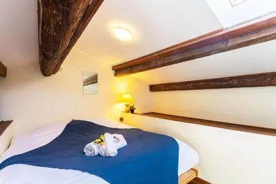 a bedroom with a bed with two stuffed animals on it at BELVEDERE AP1059 Villefranche-sur-Mer by Riviera Holiday Homes in Villefranche-sur-Mer