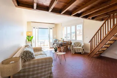 a living room with a couch and a table at BELVEDERE AP1059 Villefranche-sur-Mer by Riviera Holiday Homes in Villefranche-sur-Mer
