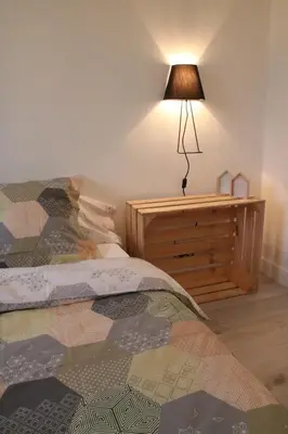 a bedroom with a bed and a lamp on a dresser at Bright Apartment Old Town in Nice