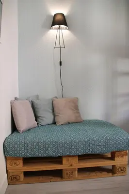 a bed with a lamp on top of it at Bright Apartment Old Town in Nice