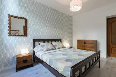 a bedroom with a bed and a mirror on the wall at Bright Apartment Old Town in Nice