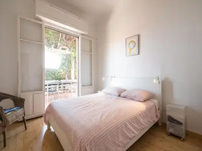 a bedroom with a bed and a large window at Elegant Seaside Villa in Èze in Èze
