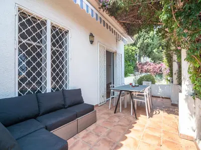a patio with a couch and a table on a patio at Elegant Seaside Villa in Èze in Èze
