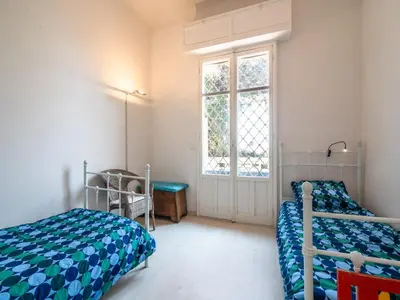 a bedroom with two beds and a window at Elegant Seaside Villa in Èze in Èze