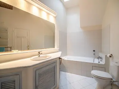 a bathroom with a sink and a toilet and a tub at Elegant Seaside Villa in Èze in Èze