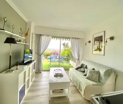 a living room with a couch and a table at Eden Barmassa in Villefranche-sur-Mer