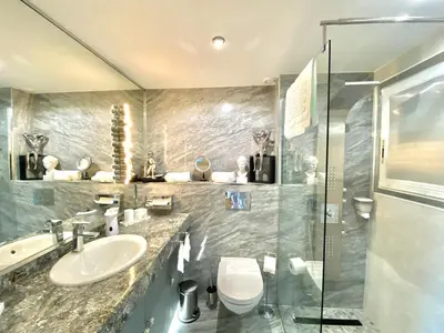 a bathroom with a sink and a toilet and a shower at Eden Barmassa in Villefranche-sur-Mer