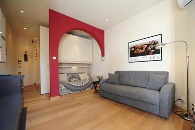 a living room with a couch and a bed at Mini Suite Miro Five Stars Holiday House in Nice