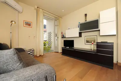a living room with a couch and a flat screen tv at Mini Suite Miro Five Stars Holiday House in Nice